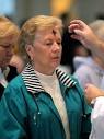 Mary Kathryn Dinsmore of Cumming receives ashes from Rev. Paul Flood. - slideshow_1002098456_ashwednesday.0310_06