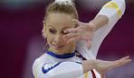 ... Russia`s Nikolay Kovalev stands on the medal stand after winning the ... - oly-30jlab-11