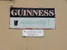 Old signs on Clancy's Pub in Clonea Power, from the days of cheap cigarettes - via Daymix
