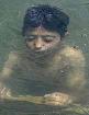 A Kashmiri boy cools himself in the waters of Dal Lake to escape the ... - nat1