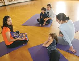 Listening in are Adam Legg, 4, and Julie Legg, left, and Dayna Rodgers with 7-year-old Gabrielle Rodgers. - bookreading