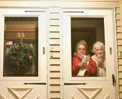 Carol Deady and her mother, Rose DeMattia, welcome a group in front of their home. (Wiqan Ang for The Boston Globe). By James Reed - 539w