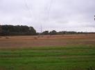 Power lines pass over farm land near to Harey Dene. - via Daymix