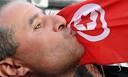 A man kisses the Tunisian flag