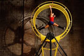 5, 2010 photo, Cassandre Joseph leaps inside a spinning wheel called \u0026quot;Gizmo\u0026quot; while rehearsing for upcoming shows at the Streb Laboratory for Action ... - d32_21755029