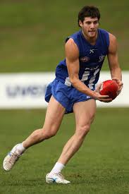 Alan Obst of the Kangaroos runs with the ball during a North Melbourne Kangaroos AFL training session held at Arden Street Oval on June 23, ... - North+Melbourne+Kangaroos+Training+Session+A5w70LDxgP1l