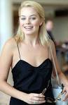 MARGOT ROBBIE cuts a completely different figure as she crosses.
