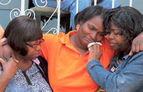 A relative wipes away the tears of Patricia Larry at a news conference in Milwaukee on June 2, 2012. Larry is the mother of Darius Simmons, 13, ... - patricia_larry06-19-2012