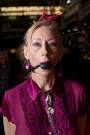A woman wearing a ball gag