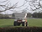 Ammonium nitrate being applied to pasture land by a spinning disc spreader. - via Daymix