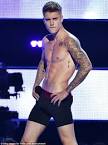 Justin Bieber strips down to his underwear at Fashion Rocks show.