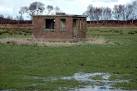 Disused brick building on Bowness Common. This is one of many old buildings - via Daymix