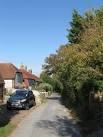 Back Lane runs parallel to the main lane running through the small hamlet. - via Daymix