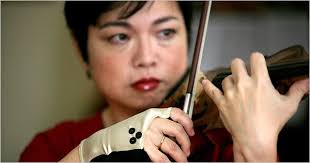 Violinist Mari Kimura wearing a glove with electrodes that monitor the angle and speed of her bowing arm. - MARI-1-articleLarge