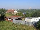 Utility Land. Rough and ready corrugated compound for caravans and skips. - via Daymix