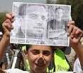 A young boy holds a photo of Mohammad Othman during a weekly peace protest ... - nilin2