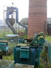 Disused electrical transformers alongside the chimney base and steam - via Daymix