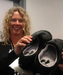 COSY FEET: Catwalk Trust general manager Cath Hopkin shows off a pair of slippers that are part of the trust\u0026#39;s latest money-generating campaign for its ... - 2987385