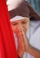 A reenactor prays during one of the station stops Friday. - jpeg