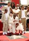 Diddy day care: Doting hip hop star holds court...in the sand pit ...