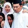 ... embraces his daughter Nurul Ilham, centre, and Nurul Hana, bottom, ... - 2104b