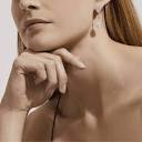 Aura pear-shaped diamond earrings | De Beers US
