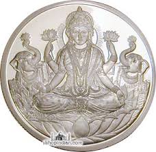 This silver coin has an embossed picture of Laxmi, Goddess of Wealth. She is being adorned by two elephants with lotus flowers. - MFFJGG4E1silver_coin