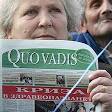 A protesting nurse shows the first page of the medical newspaper Quo Vadis,