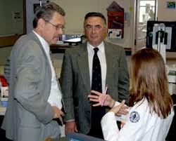 Dr. Juan Parodi (center) observes as Dr. Michael Dahn (left) discusses one of his cases on the seventh floor of John Dempsey Hospital. - photo_dahn_parodi