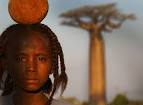 Girl with baobab fruit on her