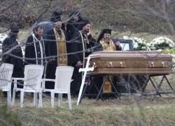 Casket and priests at gravesite of Ilia Pavlov. - pavlov1%20250