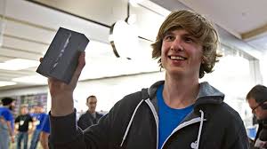 Olivier Levesque, walks out of the Place Sainte-Foy Apple Store with the first iPhone 5 sold, in Quebec City on Friday, Sept. 21, 2012. - image