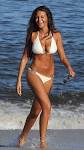 Coronation Street star MICHELLE KEEGAN sizzles on beach in white.