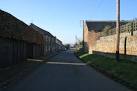 The road bends to the right at climbs up the hill to the church which is out - via Daymix