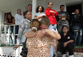 ... Claribel Cruz, surrounded by family members and friends who gathered at her home in the Heights a day after her son, Juan Batista, 26, was shot to death ... - mothers_grief-1