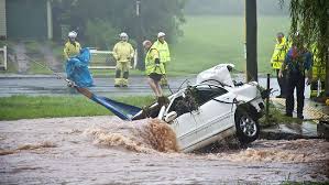 Courier Mail. A car is pulled out of the water