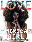 Kim Kardashian poses with Kendall Jenners new Love magazine cover.