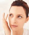 A woman touching her eyebrow