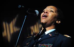 Leslie Battle, a member of Headquarters and Headquarters Battery, 174th Air Defense Artillery Brigade and a Tyler, Texas, native, sings &quot;God Bless America&quot; ... - anthem