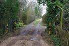 Not a speed bump, a speed dip. The yellow-banded posts mark a dip in the - via Daymix
