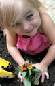 child planting a flower