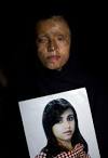 Saira Liaqat, 26, poses for the camera as she holds a portrait of herself ... - acid_terror_women_funzug_org_11