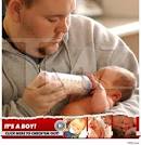 Scott Moore feeding his son;