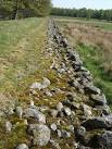 NJ7301 : Cobblestone wall of causeway across Red Moss - via Daymix