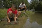 A young boy lifts his catch of - via Daymix