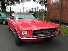 A red Ford Mustang 4700 cc - via Daymix