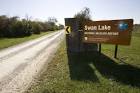 Entrance sign for swan lake - via Daymix