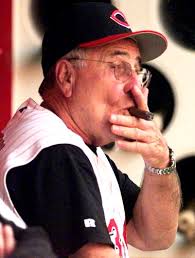 Reds manager Jack McKeon puffs on a cigar in the dugout prior to the game. (Michael E. Keating photo) - 091299mckeon_379x500