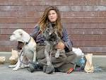 Homeless woman with dogs — - via Daymix