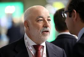 Russian billionaire Viktor Vekselberg speaks to an attendee at the.